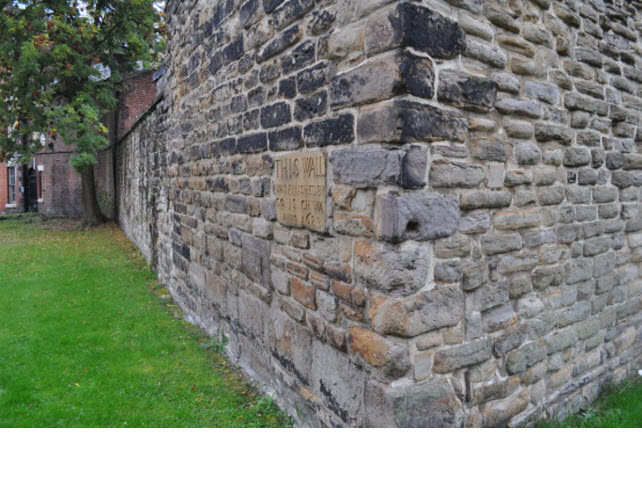 Section of wall bounding All Saints Church Yard on South